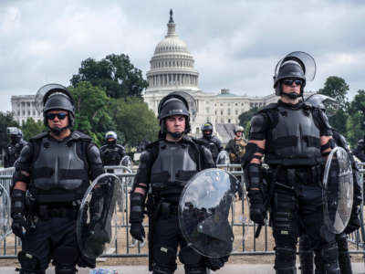 Riot cops glare while standing in front of the U.S. capitol