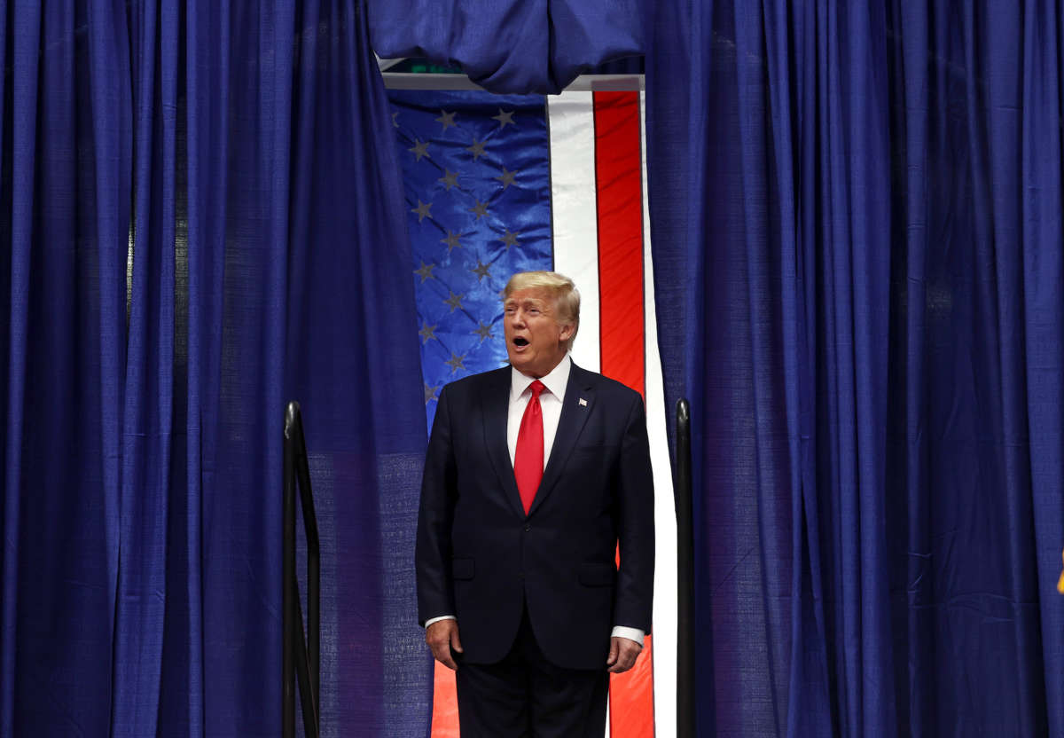 Donald Trump stands in a doorway, yelling