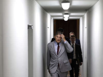 Sen. Joe Manchin (D-West Virginia) walks through the U.S. Capitol Building as he goes to a luncheon with Senate Democrats on June 14, 2022 in Washington, D.C.