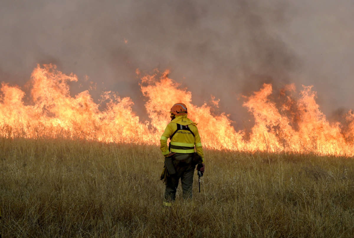 A firefighter stands guard as he looks at fire in the village of Tabara, near Zamora, northwest Spain, on July 18, 2022. Emergency services battled several wildfires as Spain remained in the grip of an exceptional heatwave that has seen temperatures reach 43 degrees Celsius (109 degrees Farenheit).