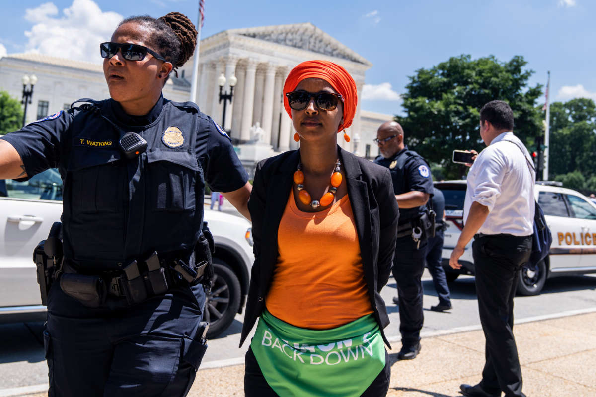 Rep. Ilhan Omar is escorted away from a sit-in outside of the Supreme Court with members of Congress to protest the decision to overturn of Roe v. Wade on July 19, 2022. 