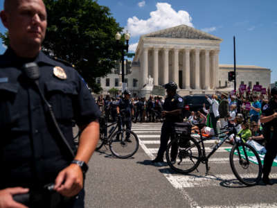 Members of Congress and activists from the Center for Popular Democracy Action (CDPA) are detained outside the Supreme Court during a sit-in on Capitol Hill on July 19, 2022, in Washington, D.C.