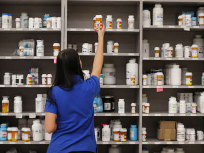 A pharmacy technician grabs a bottle of drugs off a shelve at the central pharmacy of Intermountain Healthcare on September 10, 2018, in Midvale, Utah.