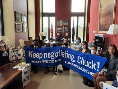 17 congressional staffers sit in at Chuck Schumer’s office in the Senate, demanding that he reopen climate negotiations, on July 25, 2022.