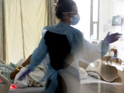 A nurse checks on a patient in the acute care COVID-19 unit at the Harborview Medical Center on January 21, 2022, in Seattle, Washington.