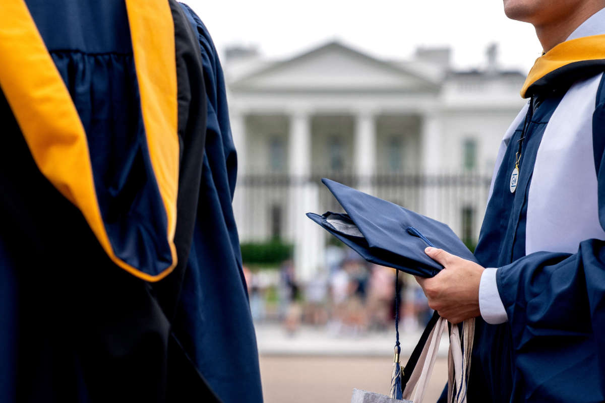 Students from George Washington University wear their graduation gowns outside of the White House in Washington, D.C., on May 18, 2022.