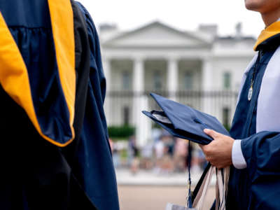 Students from George Washington University wear their graduation gowns outside of the White House in Washington, D.C., on May 18, 2022.