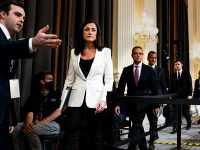 Cassidy Hutchinson, an aide to Trump White House chief of staff Mark Meadows, enters to testify as the House Janurary 6 select committee holds a hearing on Capitol Hill on June 28, 2022.