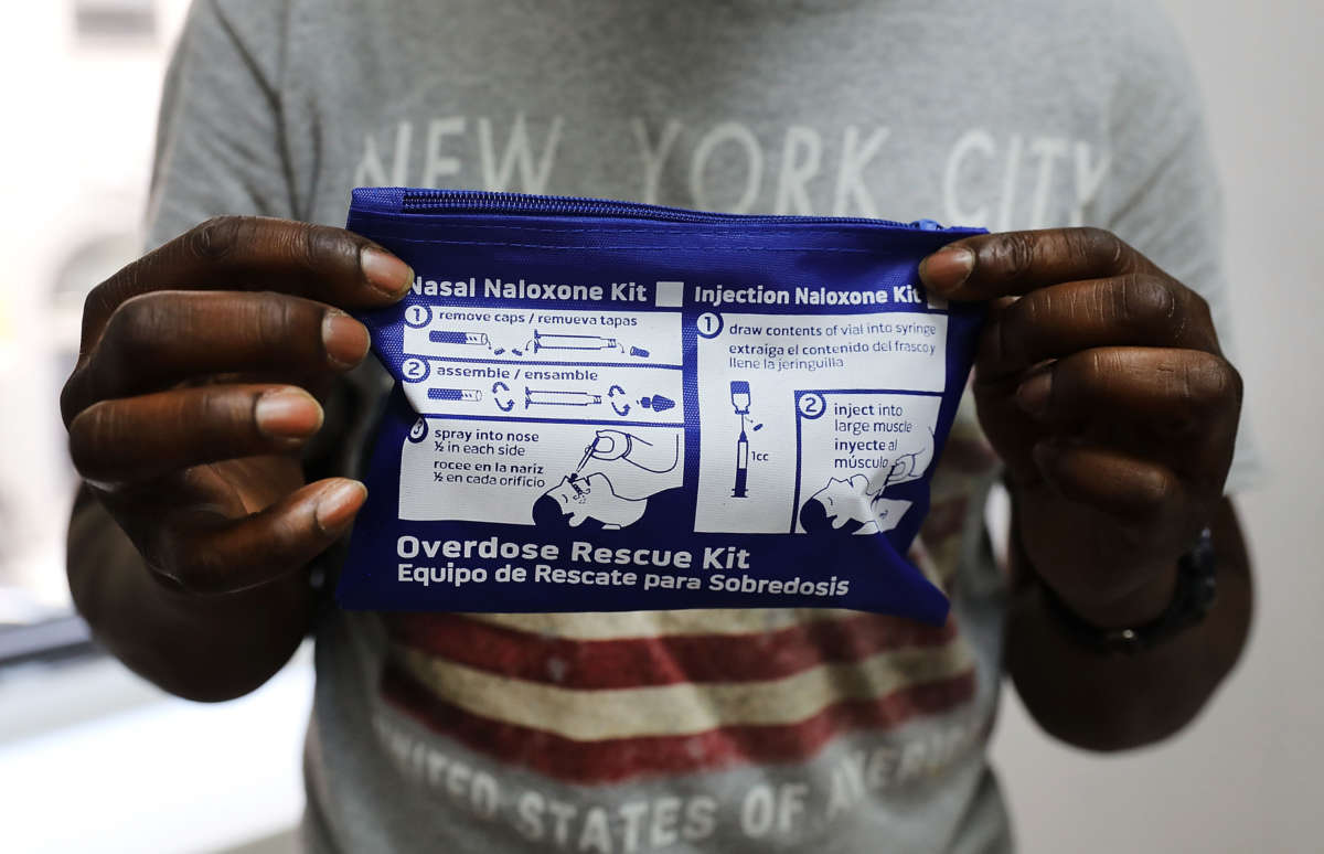 A man holds a naloxone kit