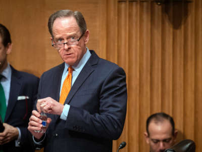 Sen. Pat Toomey waits for the start of the Senate Banking Committee hearing on February 15, 2022, in Washington, D.C.