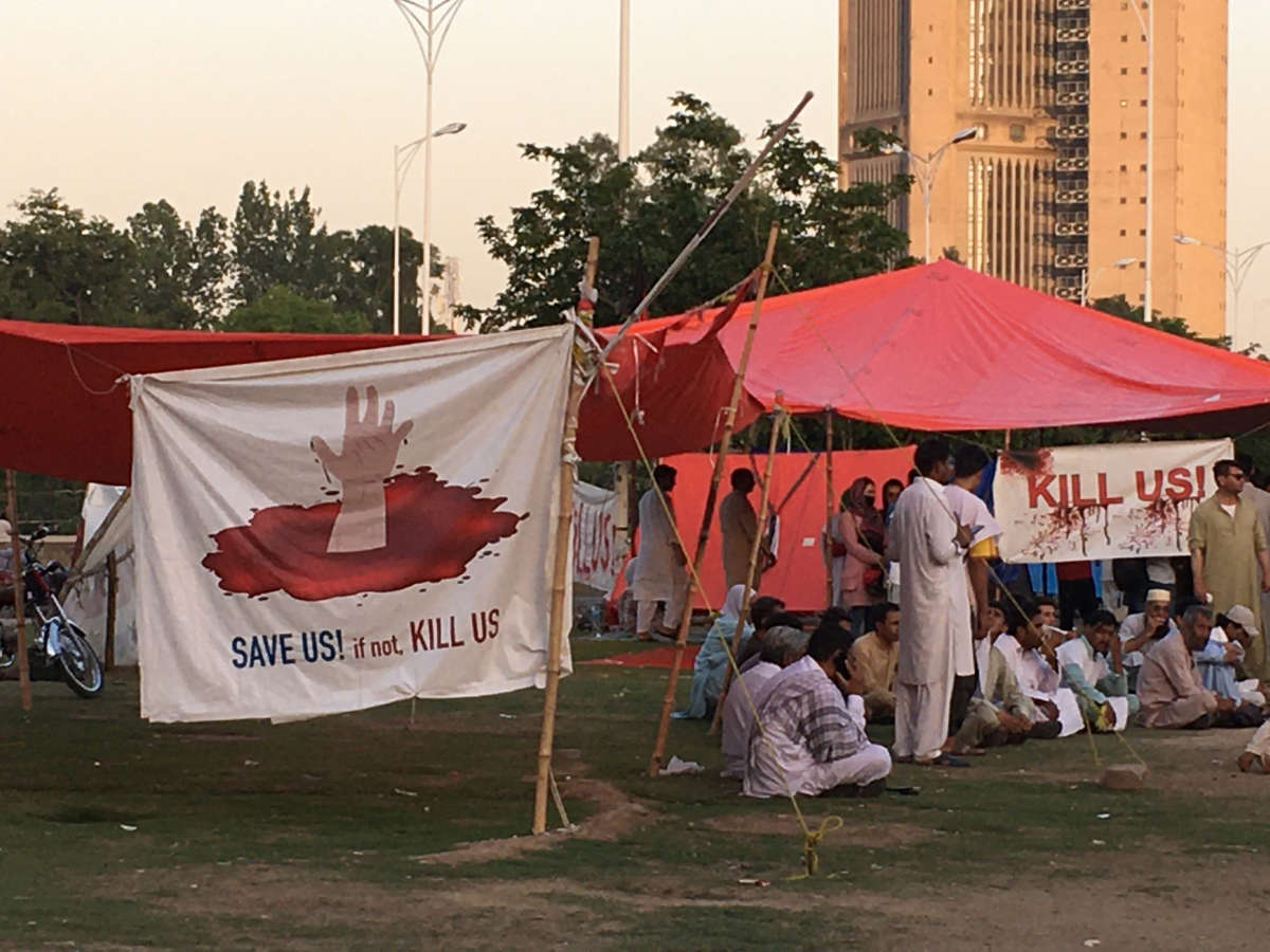 A sign at a makeshift Afghan refugee camp in Islamabad, Pakistan, reads 'Save Us! If not, kill us!'