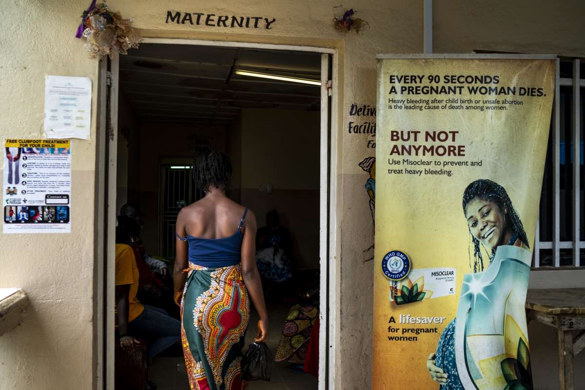 A woman enters a maternity clinic in Sierra Leone