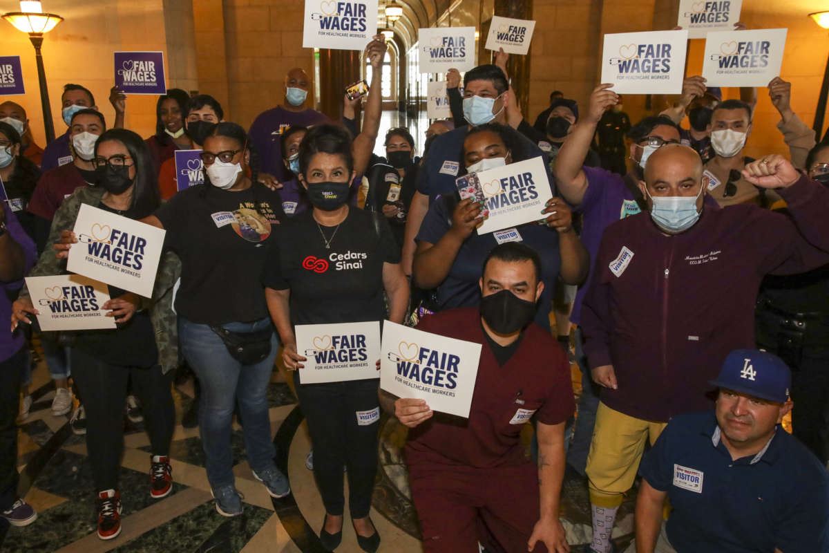 Health care workers celebrate as Los Angeles City Council gives a final approval to an ordinance raising the minimum wage for people working at some health care facilities in the city to $25 per hour on June 29, 2022, in Los Angeles, California.