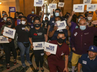 Health care workers celebrate as Los Angeles City Council gives a final approval to an ordinance raising the minimum wage for people working at some health care facilities in the city to $25 per hour on June 29, 2022, in Los Angeles, California.