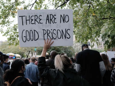 Protest sign saying "There are no good prisons" outside of Rikers Jail