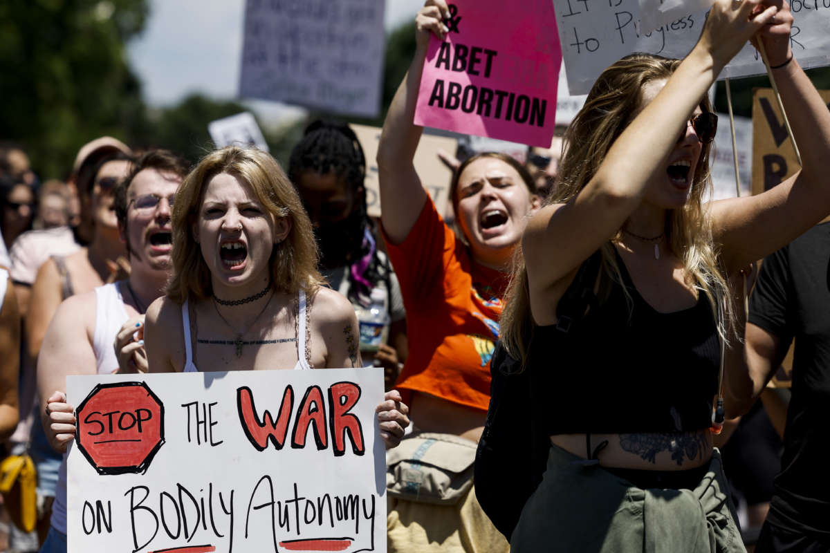 Protester holds sign saying "Stop the war on bodily autonomy"