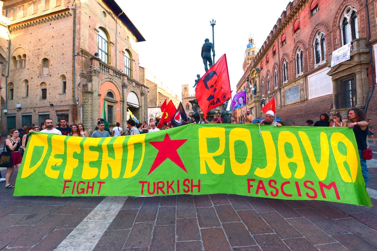 People gather during a "Stop Erdogan, Free The Rojava Revolution" Kurdish-led protest against Turkish government policy on the 10th anniversary of the Kurdish Rojava Revolution at Neptune Square on July 19, 2022, in Bologna, Italy.