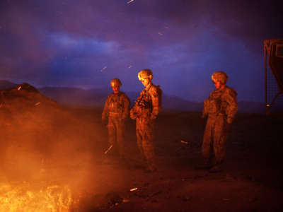 Soldiers burn trash from the Jaghatu Combat Outpost in a pit located just outside the walls of the base in Jaghatu, Afghanistan, on September 12, 2012.