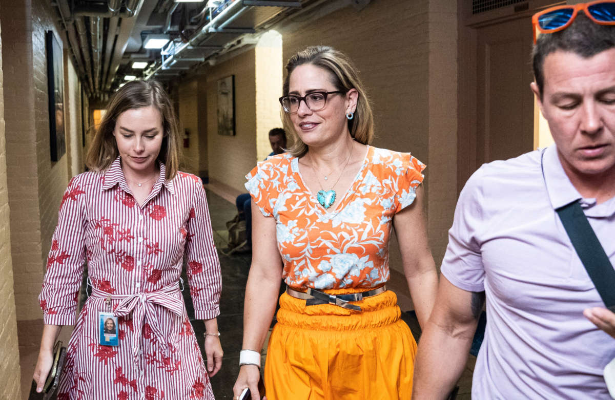 Sen. Kyrsten Sinema walks to the Senate floor for a vote on Capitol Hill on August 4, 2022, in Washington, D.C.