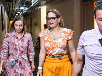 Sen. Kyrsten Sinema walks to the Senate floor for a vote on Capitol Hill on August 4, 2022, in Washington, D.C.