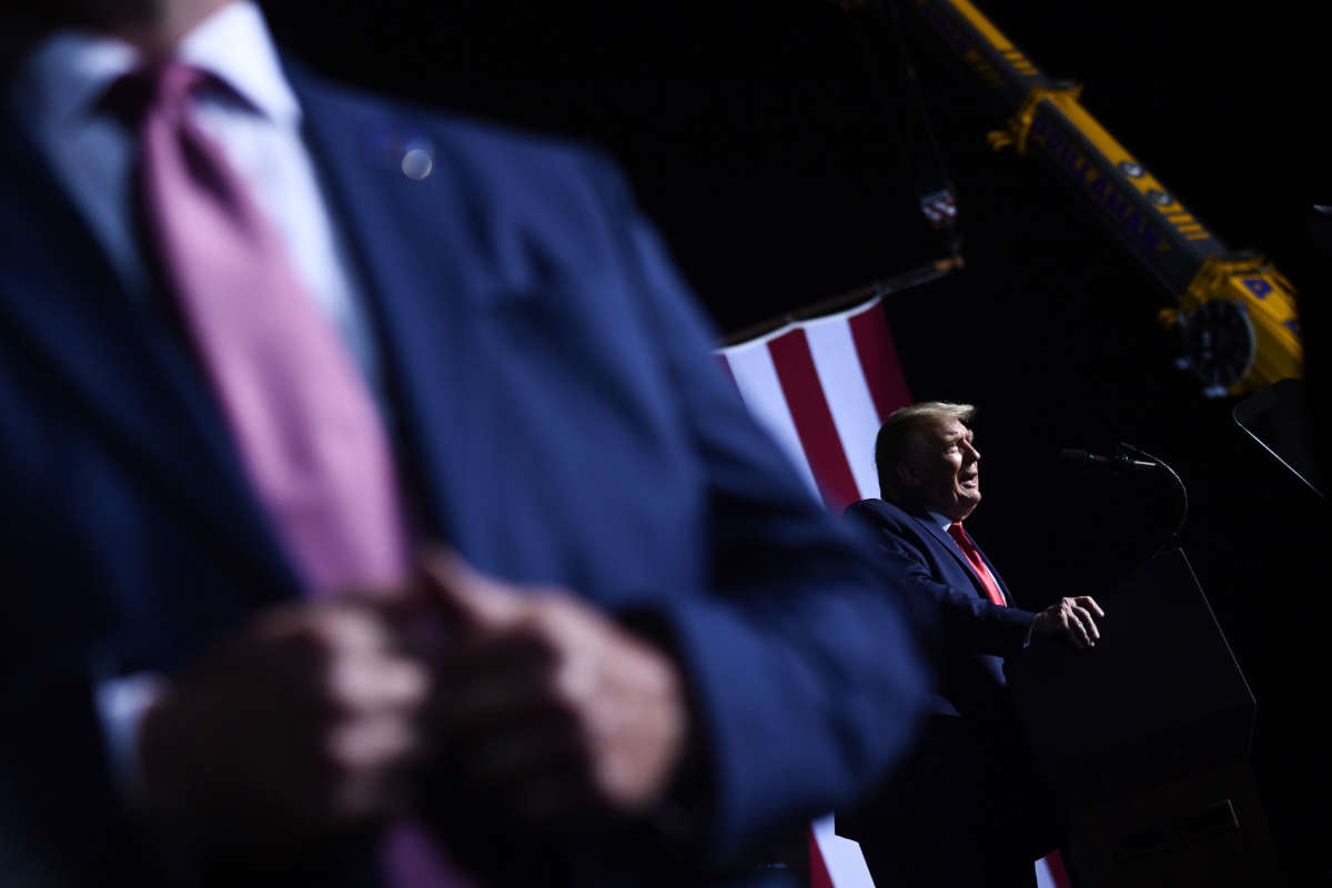 A secret service agent stands watch as then-President Donald Trump speaks during a rally on September 25, 2020, in Newport News, Virginia.