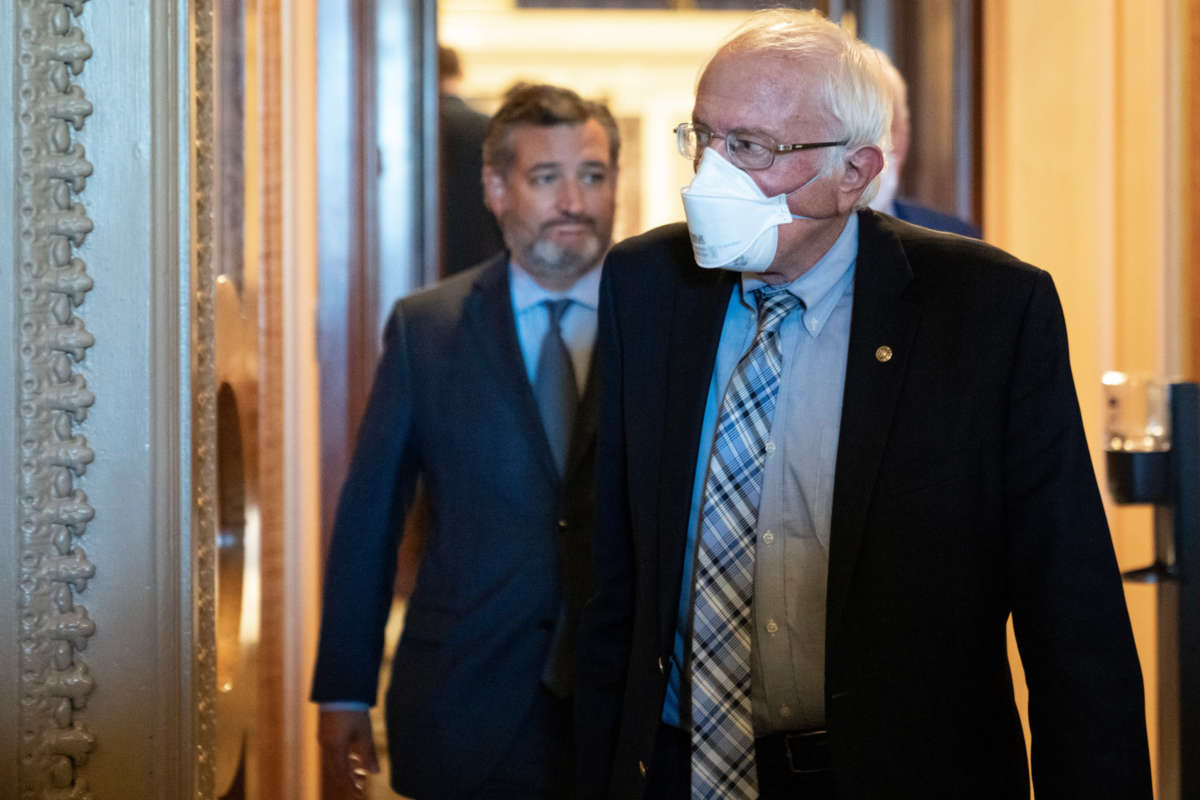 Sen. Bernie Sanders, right, and Sen. Ted Cruz leave the Senate Chamber after final passage of the Inflation Reduction Act at the U.S. Capitol on August 7, 2022, in Washington, D.C.