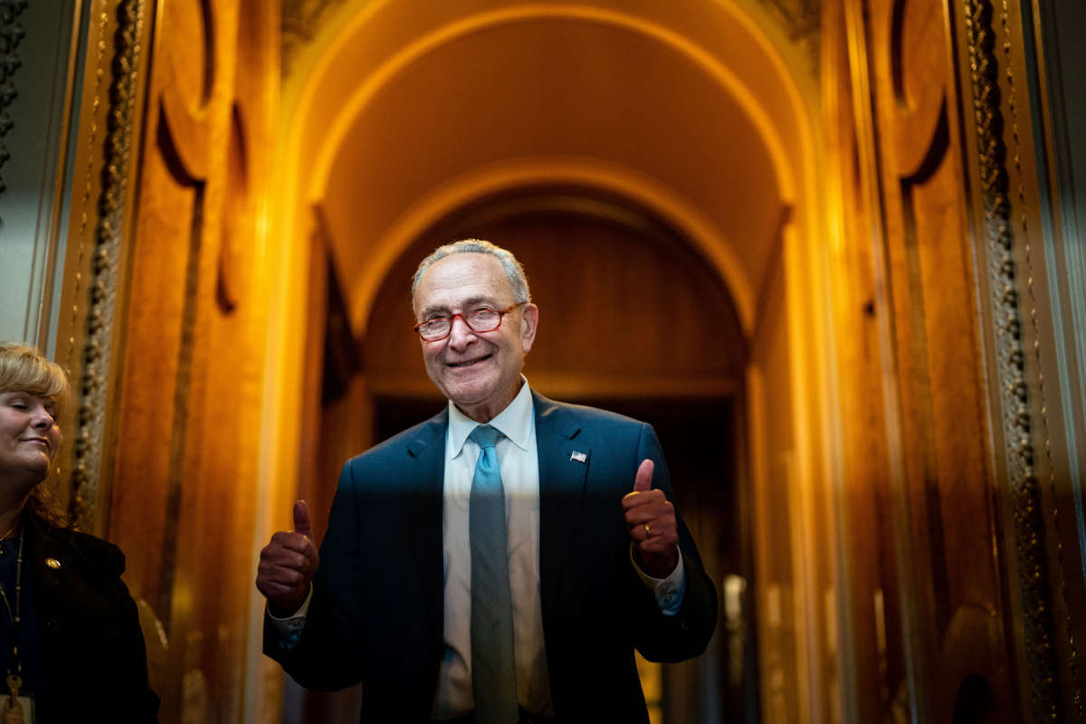 Senate Majority Leader Chuck Schumer gestures, walking out of the Senate Chamber, celebrating the passage of the Inflation Reduct Act at the U.S. Capitol on August 7, 2022, in Washington, D.C.