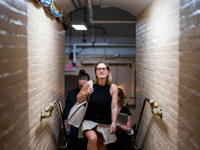 Sen. Kyrsten Sinema walks to a vote at the U.S. Capitol on July 28, 2022, in Washington, D.C.