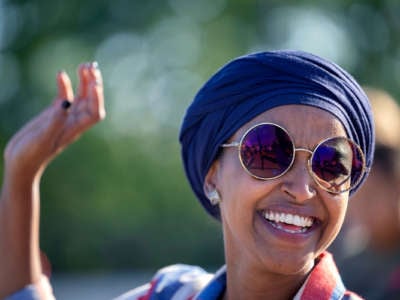 Rep. Ilhan Omar smiles as she waves to supporters