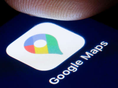 A finger hovers over the logo of the online map service Google Maps is shown on the display of a smartphone.