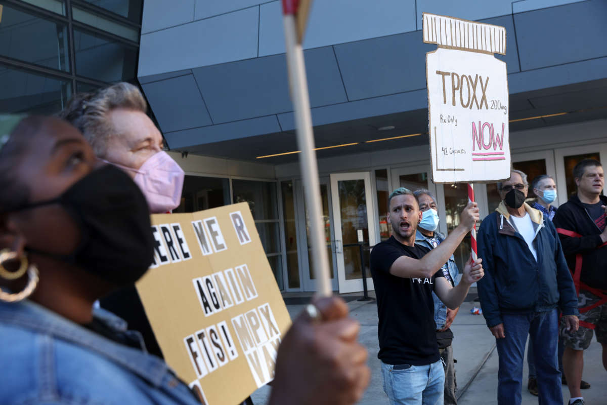 Health care and LGBTQ rights activists hold signs as they stage a protest outside of the San Francisco Federal Building on August 8, 2022, in San Francisco, California.