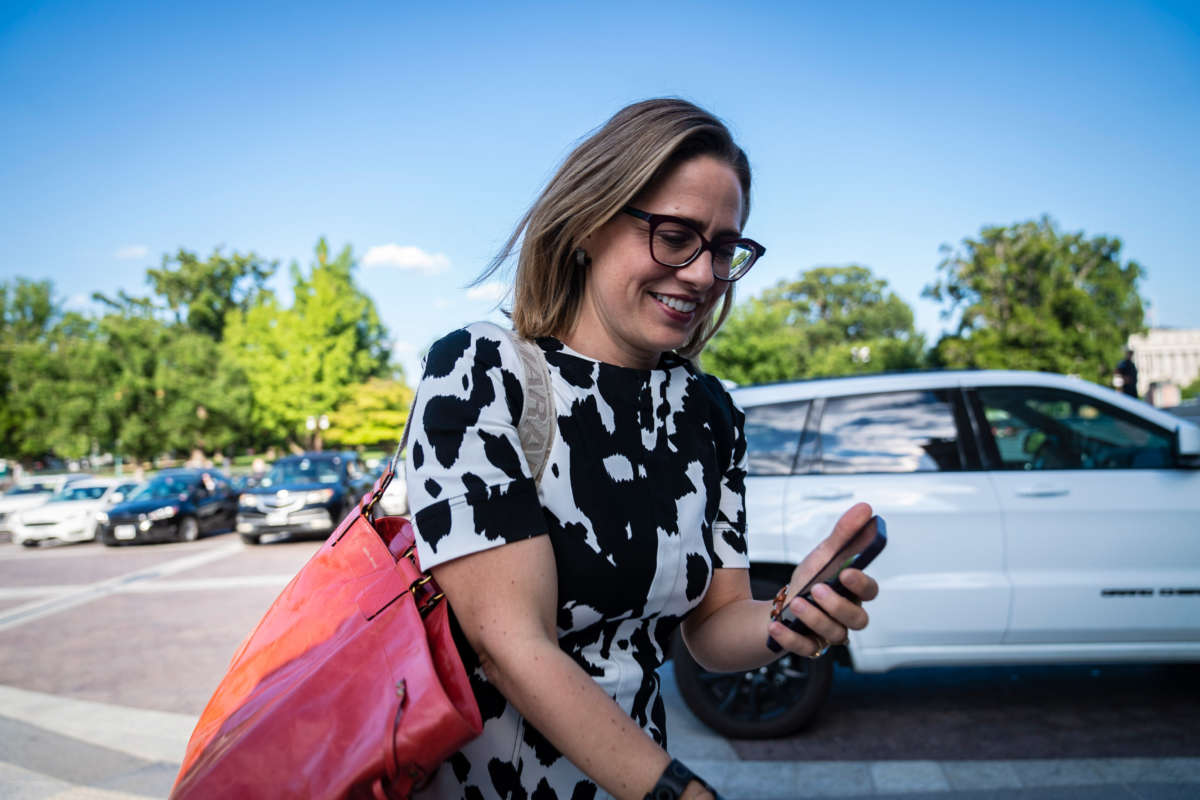 Sen. Kyrsten Sinema walks to the Senate floor for a vote on Capitol Hill on August 3, 2022, in Washington, D.C.