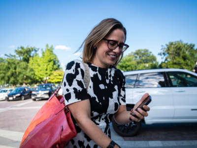 Sen. Kyrsten Sinema walks to the Senate floor for a vote on Capitol Hill on August 3, 2022, in Washington, D.C.