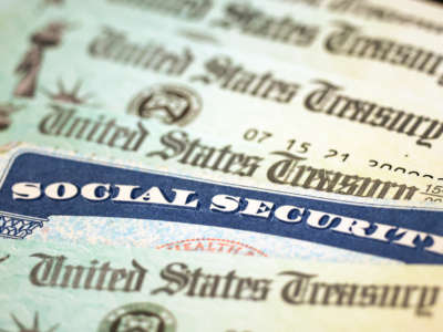A Social Security card sits alongside checks from the U.S. Treasury