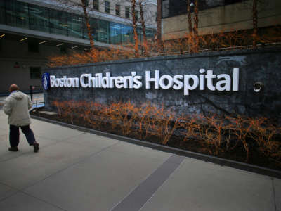 A pedestrian passes the Longwood Avenue exterior of the Boston Children's Hospital on February 26, 2020.