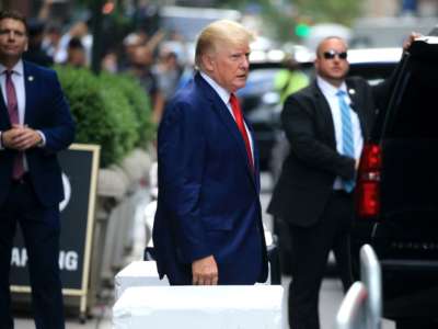 Donald Trump walks toward a car