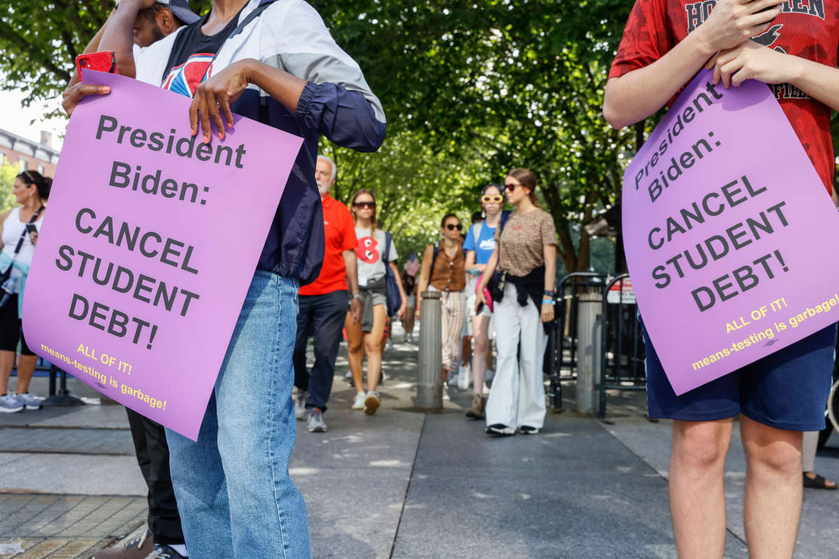 Student loan debt holders take part in a demonstration outside of the white house staff entrance to demand that President Biden cancel student loan debt in August on July 27, 2022, at the Executive Offices in Washington, D.C.