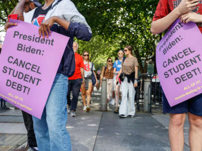 Student loan debt holders take part in a demonstration outside of the white house staff entrance to demand that President Biden cancel student loan debt in August on July 27, 2022, at the Executive Offices in Washington, D.C.