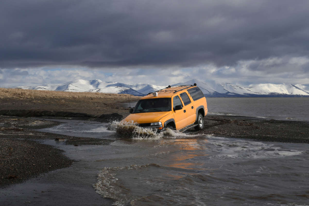 A vehicle drives beside the melting permafrost tundra on the edge of the Bering Sea at the town of Quinhagak on the Yukon Delta in Alaska on April 12, 2019.
