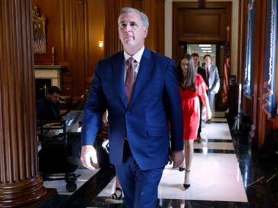 Kevin McCarthy walks down a hallway