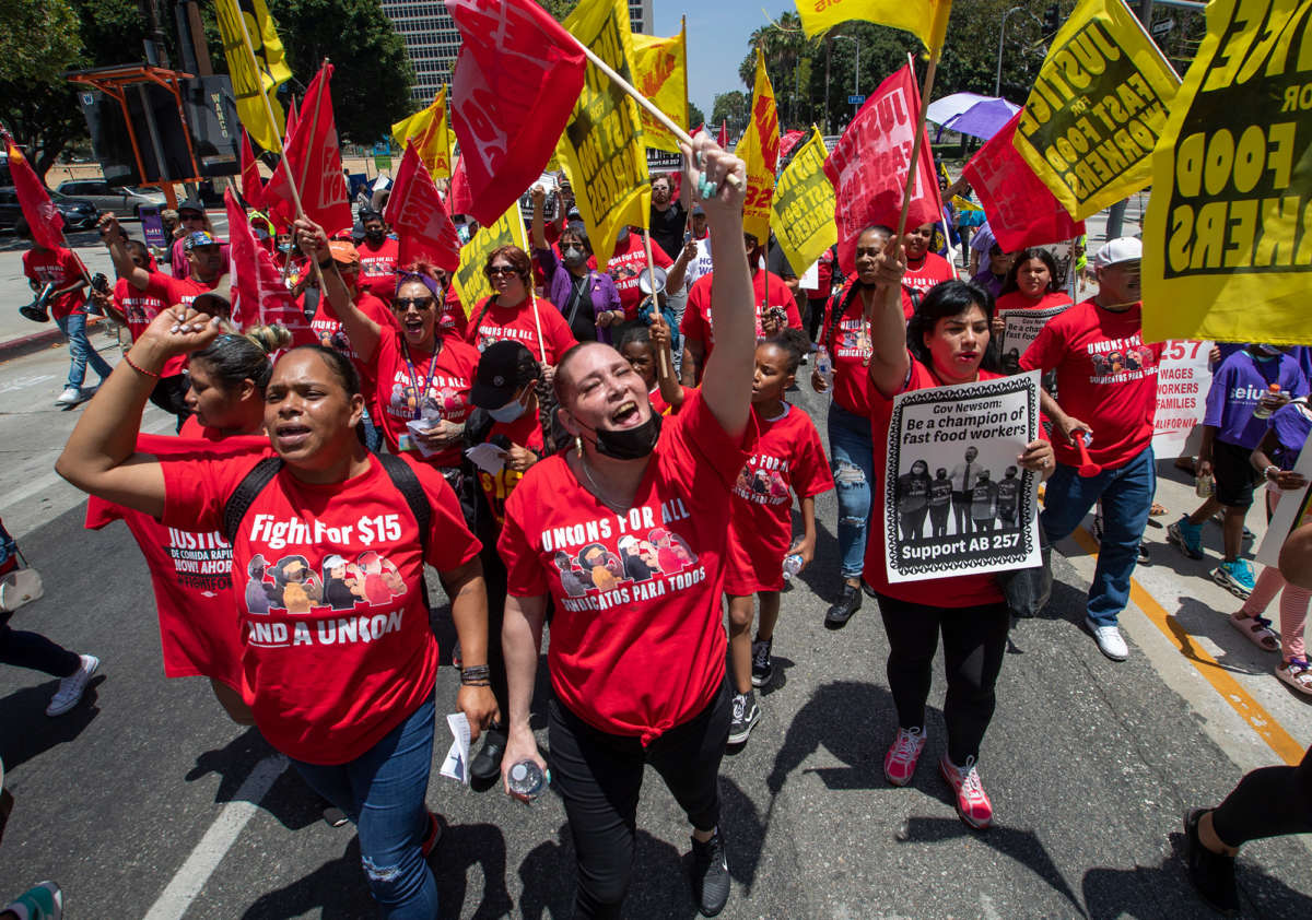 Fast food workers march to the state building on Spring Street after a rally at Los Angeles City Hall to protest unsafe working conditions and to demand a voice on the job through AB 257, on June 8, 2022.