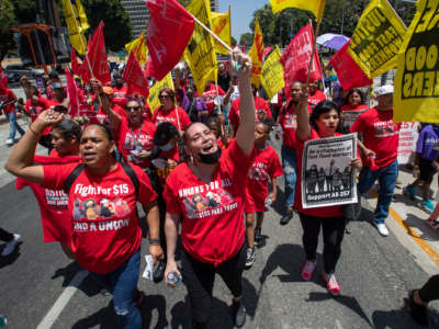Fast food workers march to the state building on Spring Street after a rally at Los Angeles City Hall to protest unsafe working conditions and to demand a voice on the job through AB 257, on June 8, 2022.
