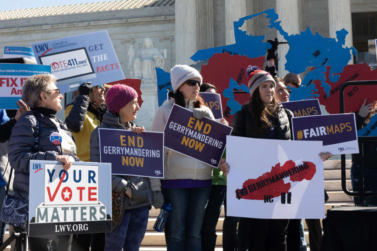 People gather outside the Supreme Court on March 26, 2019, on a day the court was hearing the Rucho v. Common Cause gerrymandering case.