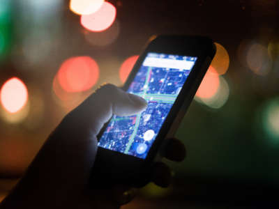 Close on cell phone in woman's hand displaying map