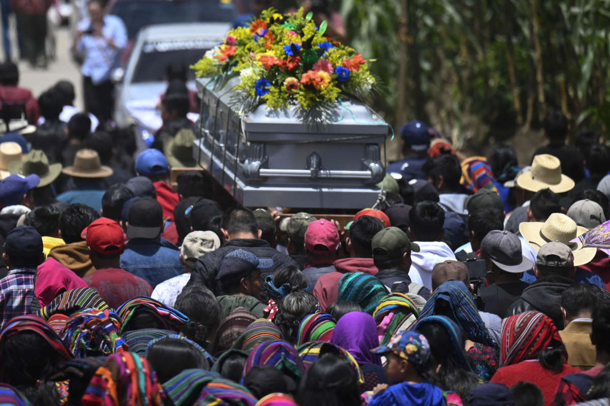 Indigenous people carry the coffin of Melvin Guachiac, a 13-year-old Guatemalan teenager who was killed inside a tractor-trailer in Texas, U.S., after crossing from Mexico, in Guatemala on July 16, 2022.