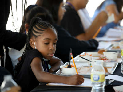 An incoming fourth-grade student at Compton Avenue Elementary School samples and tastes new breakfast and lunch menu items at Ramón C. Cortines School of Visual and Performing Arts on July 29, 2022, in Los Angeles, California.
