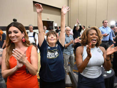 Reproductive rights supporters applaud the successful "No" vote against a Kansas constitutional amendment, which would remove the right to an abortion, at the Overland Park Convention Center in Overland Park, Kansas, on August 2, 2022.