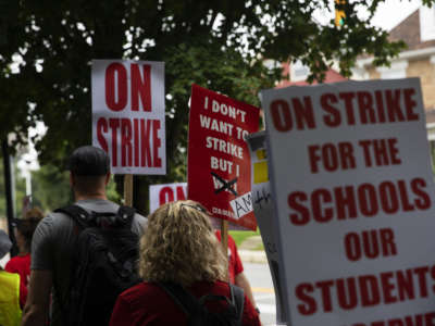 Columbus City School teachers strike outside of Livingston Elementary School in Columbus, Ohio, on August 22, 2022.