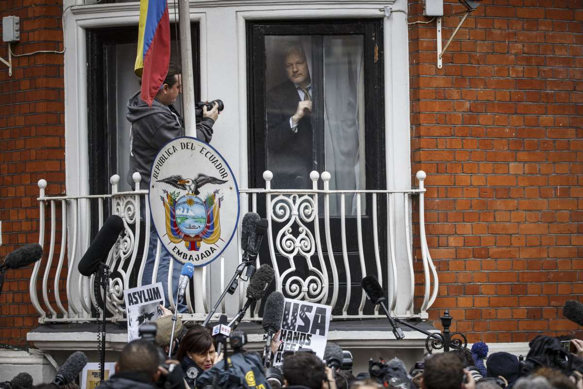 Julian Assange prepares to speak from the balcony of the Ecuadorian embassy