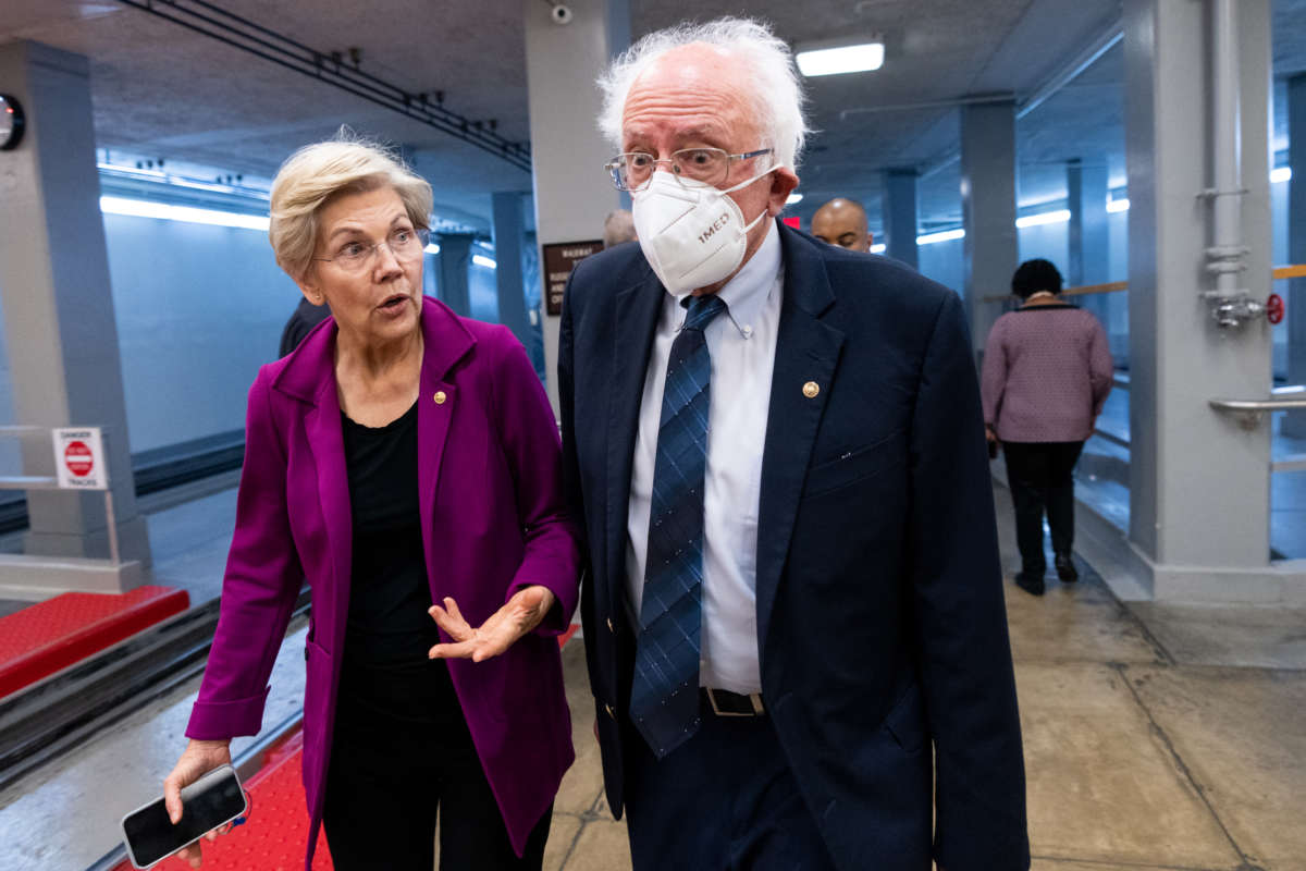 Sen. Elizabeth Warren (D-Massachusetts) and Sen. Bernie Sanders (I-Vermont), walk through the Senate subway on their way to a vote in the Capitol on Thursday, September 22, 2022.